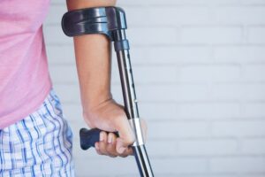 person using a short crutch